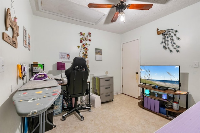 office area with ceiling fan and a textured ceiling