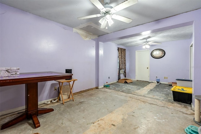 interior space featuring ceiling fan and concrete flooring