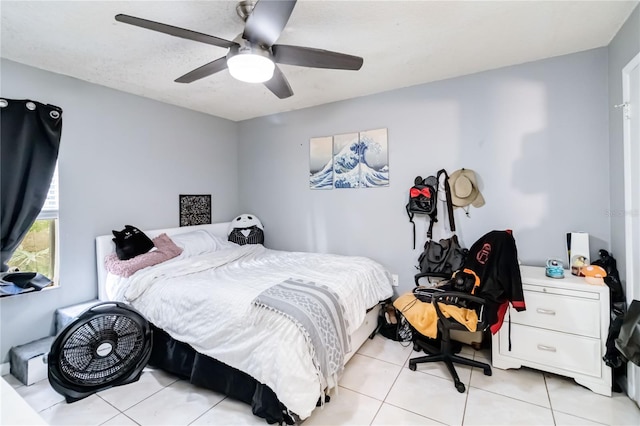 bedroom with ceiling fan and light tile patterned flooring