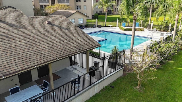 view of swimming pool with a patio area and a yard