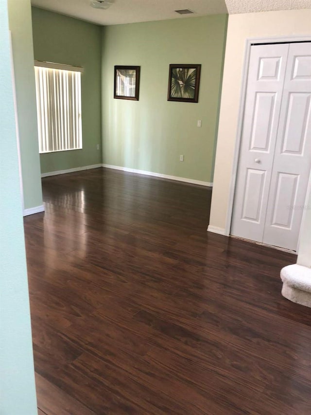 unfurnished room featuring dark hardwood / wood-style floors