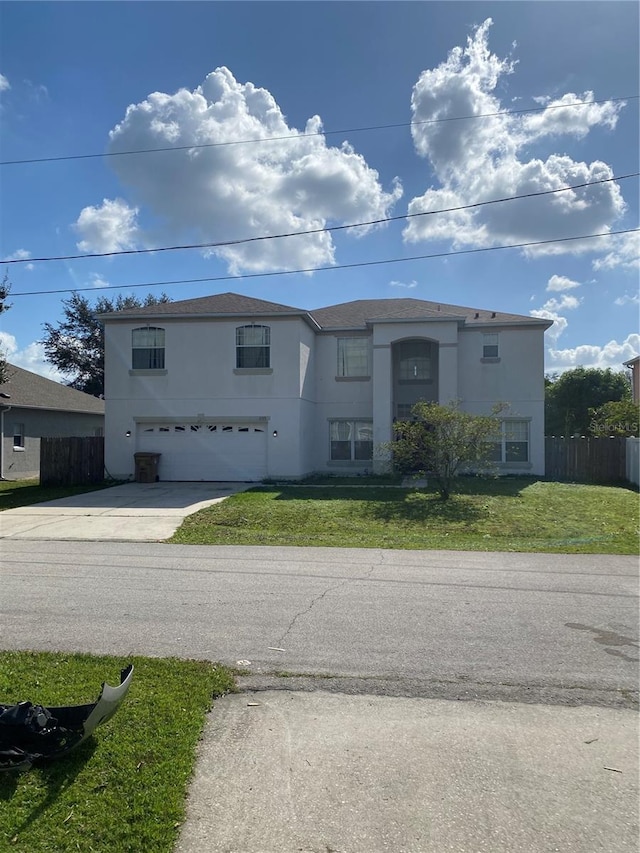 view of front of house with a front yard and a garage