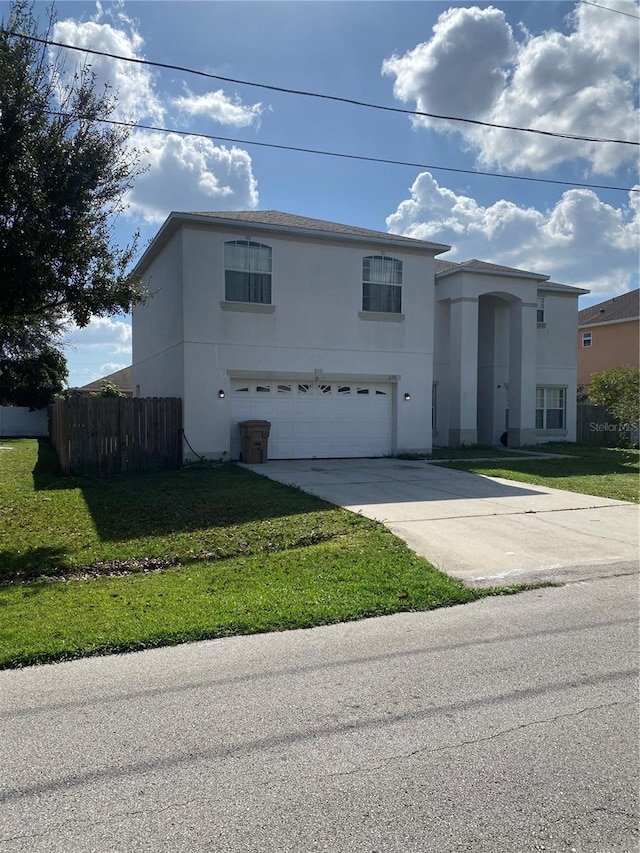 view of front of property featuring a front lawn and a garage