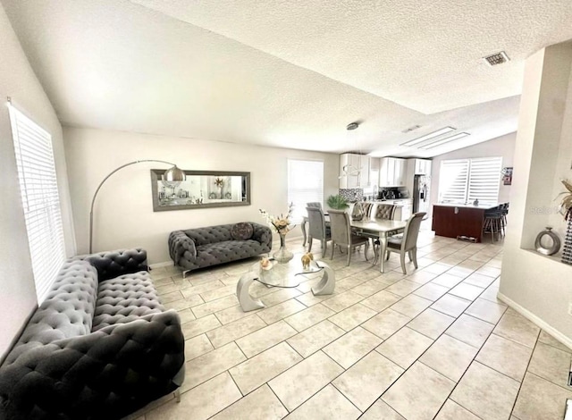 tiled living room with a textured ceiling and lofted ceiling