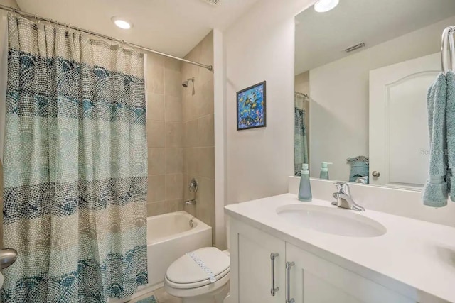 full bathroom featuring shower / bath combo, vanity, and toilet