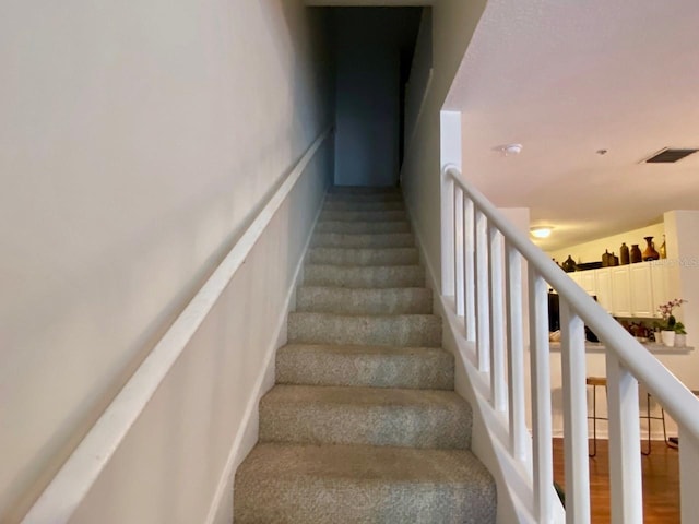 staircase with wood-type flooring