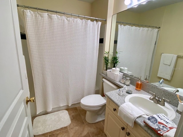 bathroom featuring tile patterned flooring, vanity, and toilet