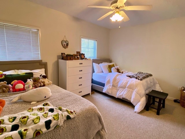 bedroom with ceiling fan and dark carpet