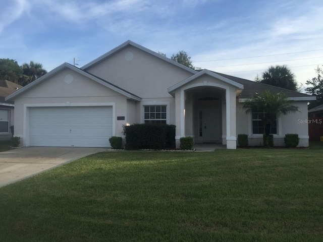 ranch-style house featuring a garage and a front lawn