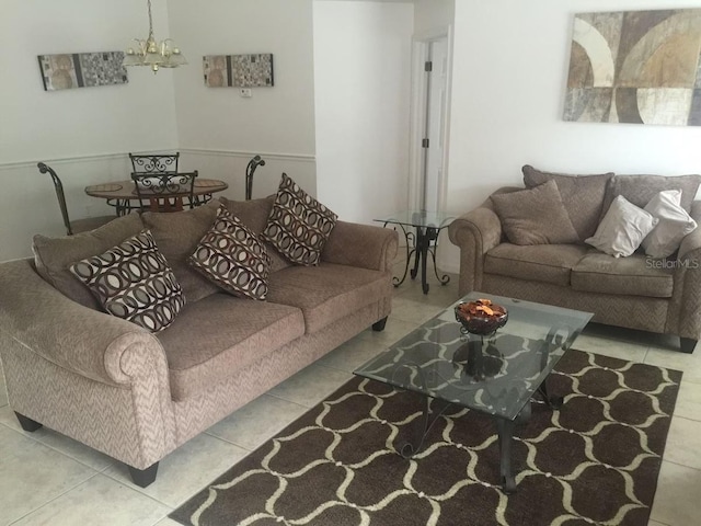 living room with a chandelier and light tile patterned floors