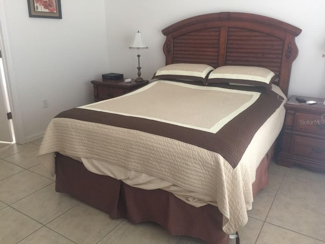 bedroom featuring light tile patterned flooring