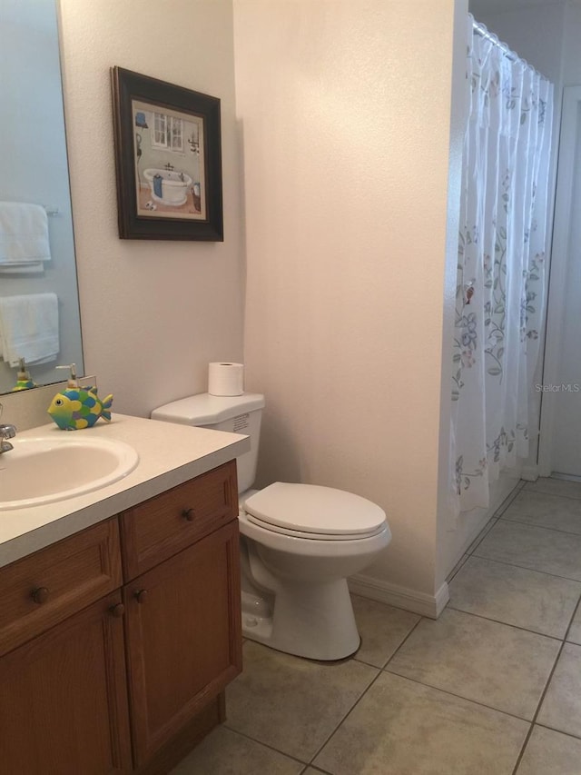 bathroom featuring vanity, tile patterned floors, toilet, and a shower with curtain