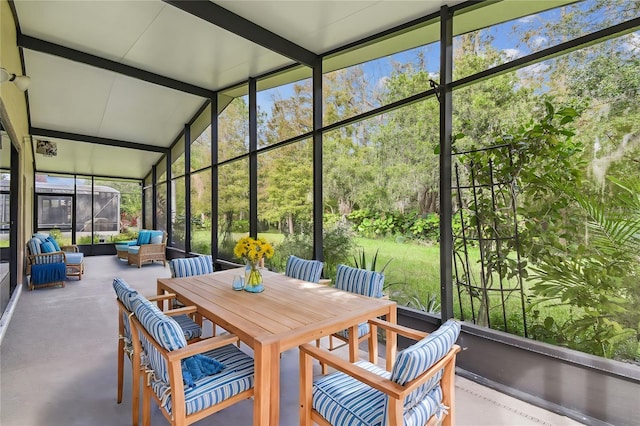 sunroom / solarium featuring lofted ceiling