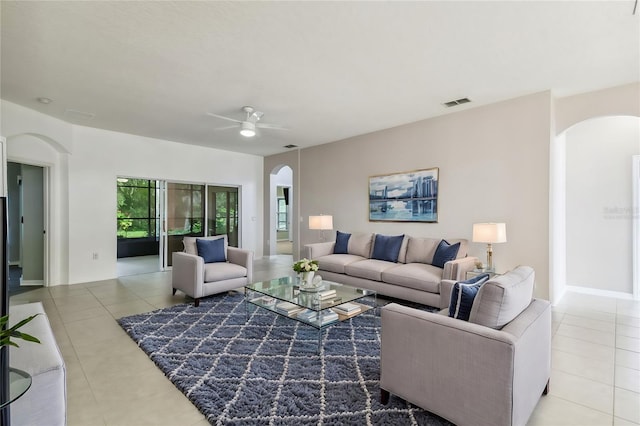 tiled living room featuring ceiling fan