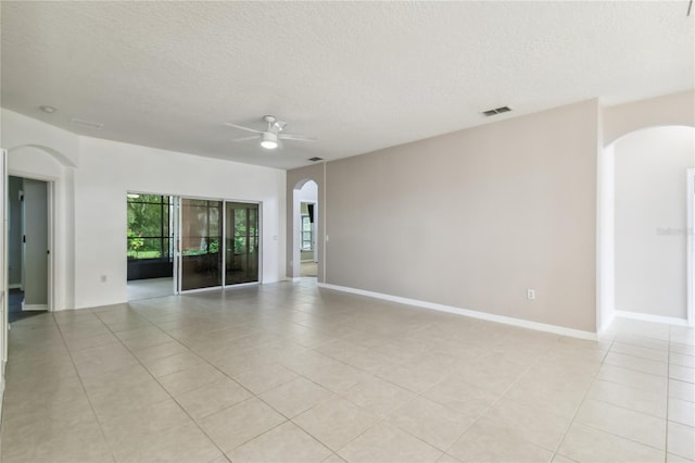 unfurnished room with a textured ceiling, ceiling fan, and light tile patterned floors