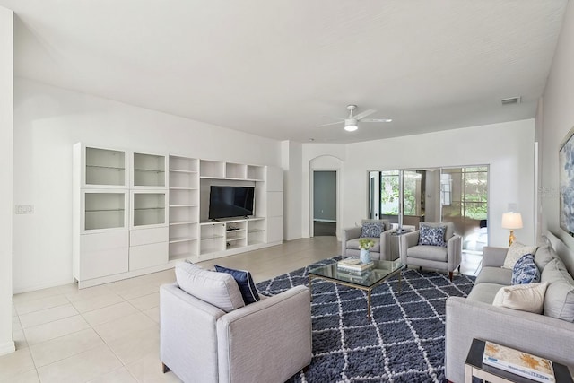 living room featuring light tile patterned floors and ceiling fan