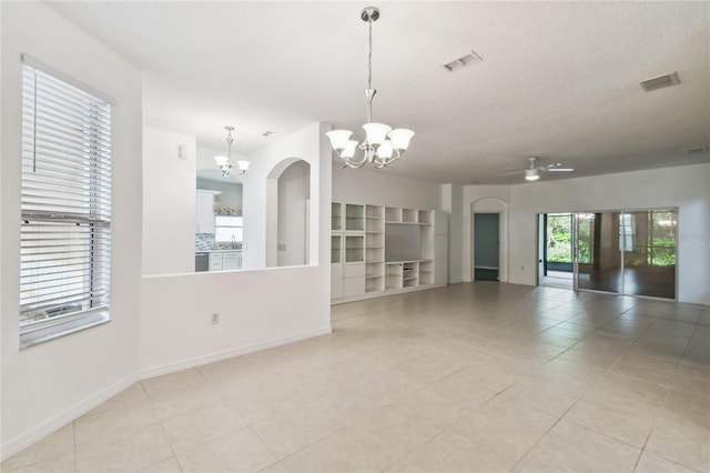 tiled empty room with ceiling fan with notable chandelier, a textured ceiling, and sink