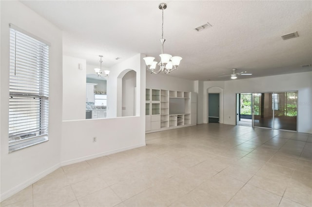 540 Genoa Dr, Poinciana, FL 34759 - unfurnished living room with a chandelier, light tile patterned floors, baseboards, arched walkways, and a sink