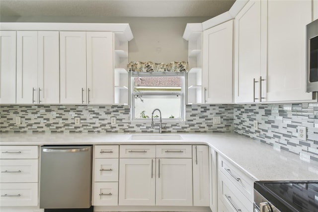 kitchen with appliances with stainless steel finishes, sink, and white cabinets