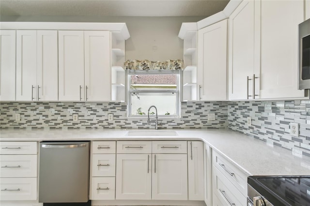 540 Genoa Dr, Poinciana, FL 34759 - kitchen with open shelves, dishwasher, a sink, and light countertops