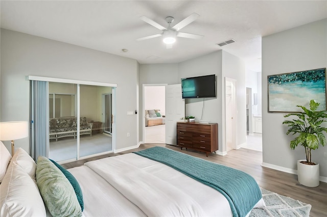 bedroom with access to outside, wood-type flooring, and ceiling fan