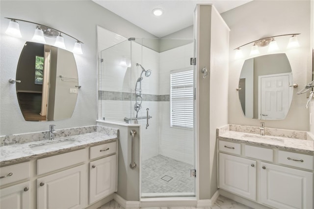 bathroom with a shower with door and vanity