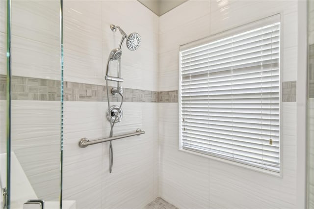 bathroom with a tile shower