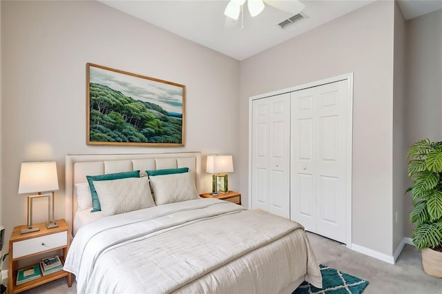 carpeted bedroom with ceiling fan and a closet