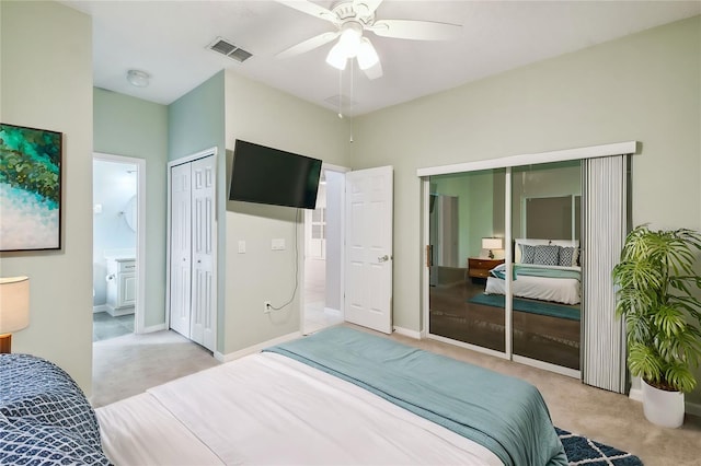 carpeted bedroom featuring ensuite bath and ceiling fan