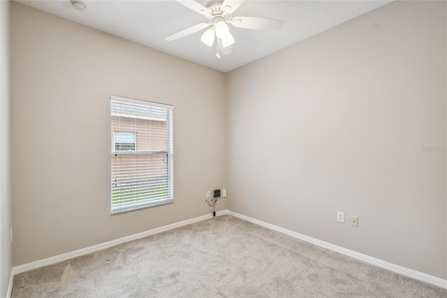 unfurnished room with light colored carpet and ceiling fan