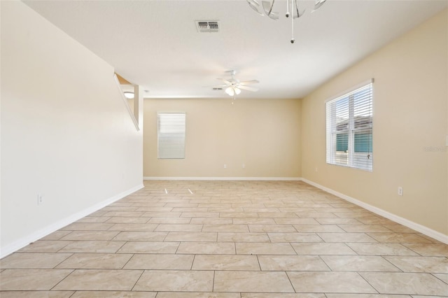 tiled spare room featuring ceiling fan