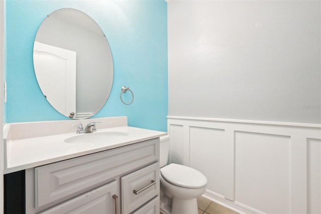 bathroom with toilet, tile patterned floors, and vanity