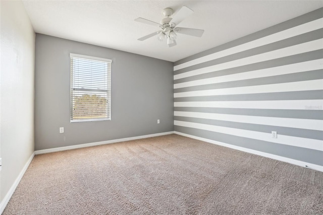 empty room featuring carpet flooring and ceiling fan