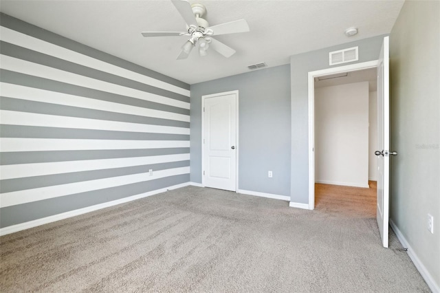 unfurnished bedroom with light colored carpet, ceiling fan, and a closet