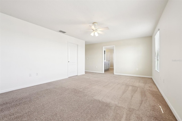 unfurnished room featuring ceiling fan and light carpet