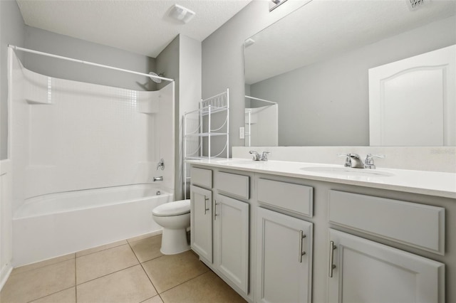 full bathroom with toilet, vanity, tile patterned floors, a textured ceiling, and shower / bathing tub combination