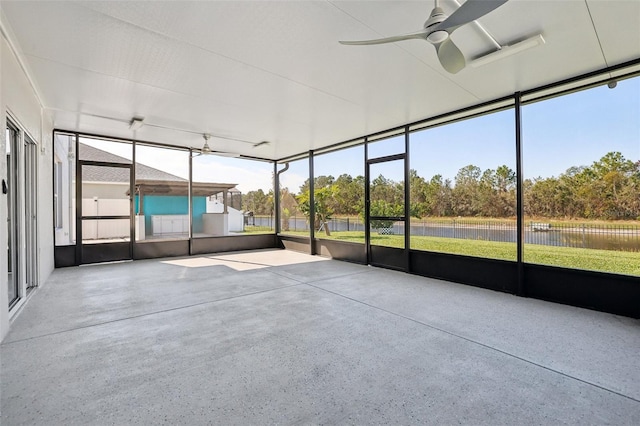 unfurnished sunroom with ceiling fan