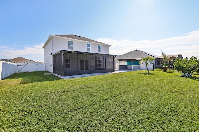 rear view of property with a lawn and a sunroom