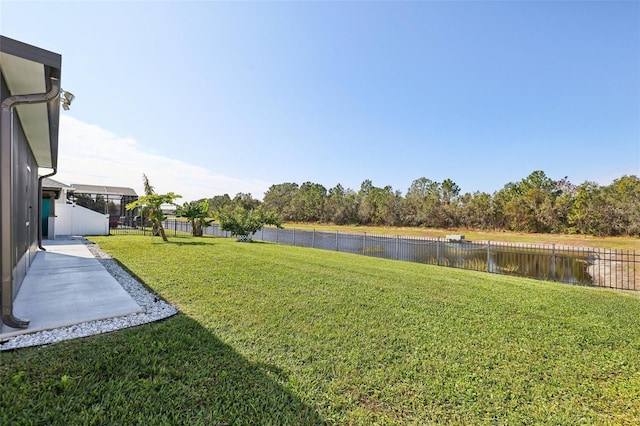 view of yard with a patio and a water view