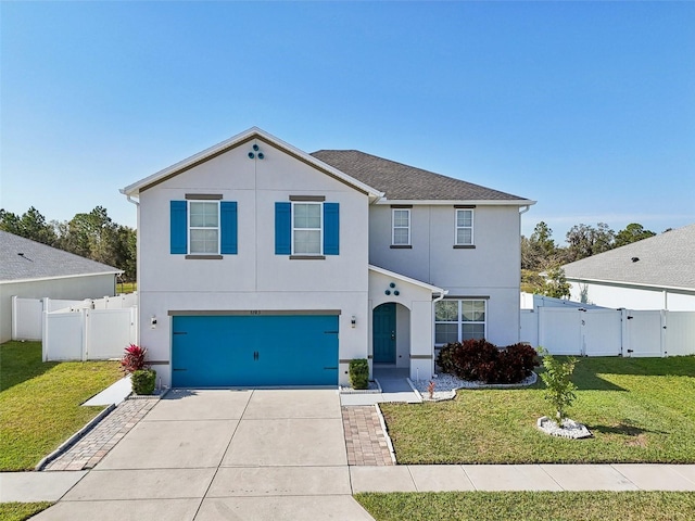 view of front of home with a front yard and a garage