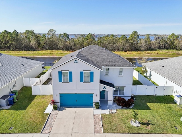 view of front facade featuring a front yard and a garage