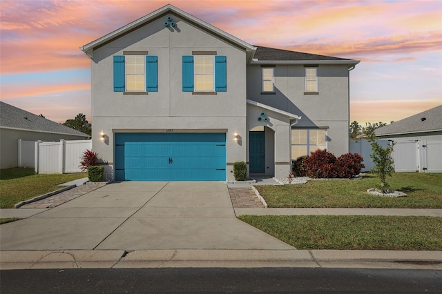 view of front facade with a yard and a garage