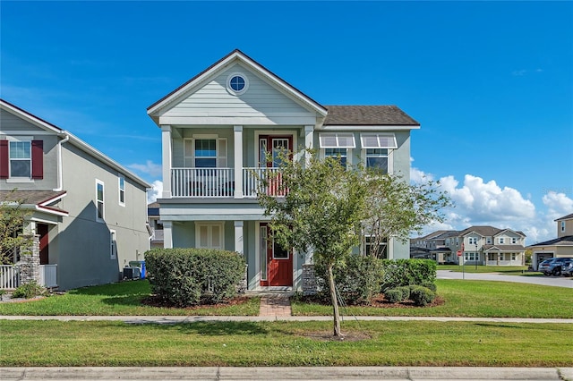 view of front of home featuring a front lawn and a balcony