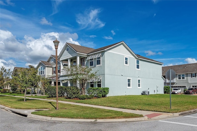 view of property exterior with a balcony, cooling unit, and a yard