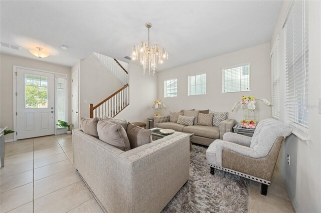 tiled living room with a chandelier