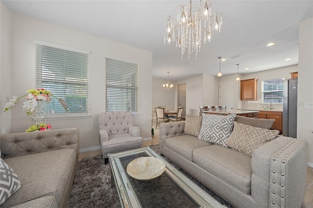 living room featuring a chandelier and sink