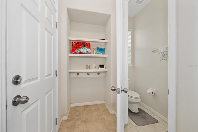 bathroom featuring toilet and tile patterned floors