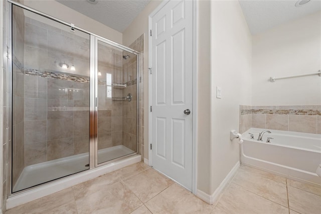 bathroom featuring tile patterned flooring, a textured ceiling, and plus walk in shower