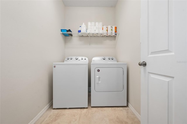 laundry room featuring light hardwood / wood-style flooring and washing machine and dryer