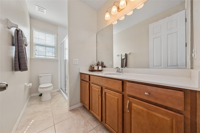 bathroom with walk in shower, vanity, a textured ceiling, tile patterned flooring, and toilet